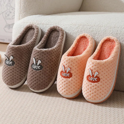 Women's plush rabbit plaid design winter slippers with a thick light-coloured rubber sole.