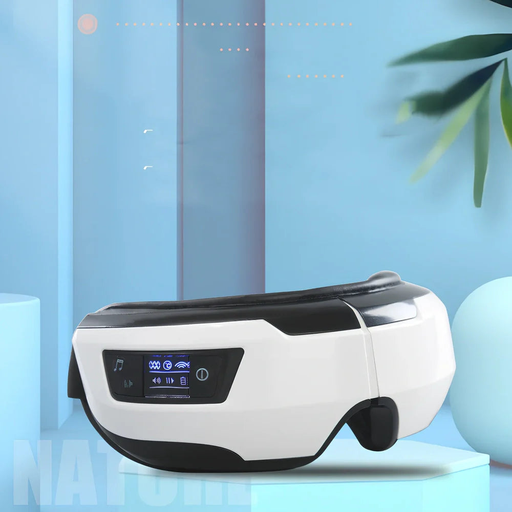 Black and white eye massager with USB cable, showing contoured design for eye socket placement