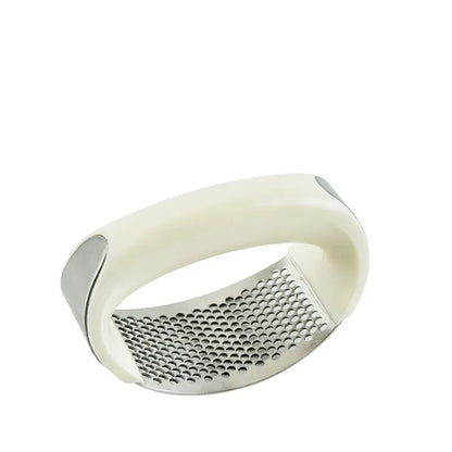 Stainless steel garlic press with ergonomic handle in kitchen setting