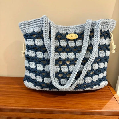 Handmade woven wool bag with floral pattern, approximately 0.5m tall