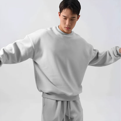 Man wearing a two-piece army green polar fleece suit with crew neck top and padded trousers.