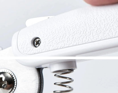 White pet nail clippers with LED light, anti-splash guard, and built-in nail file on a flat surface.