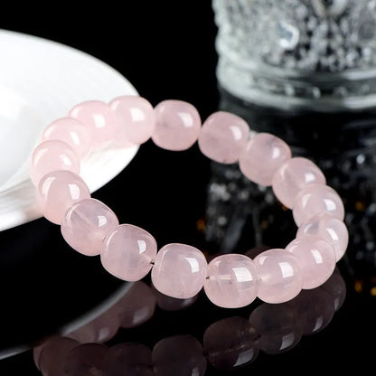 Pink crystal barrel bead bracelet with geometric design measuring 11-12mm beads on wrist