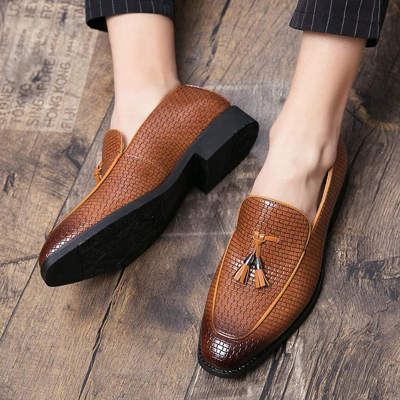 Men's black pointed toe slip on shoe with a decorative tassel on the artificial PU upper.