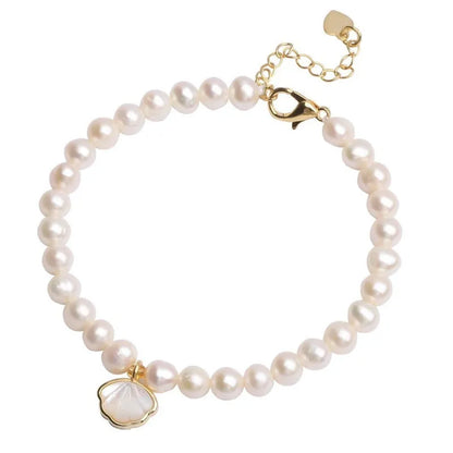 Women's freshwater pearl bracelet with fan-shell centrepiece on a 16cm elastic string or extension chain.