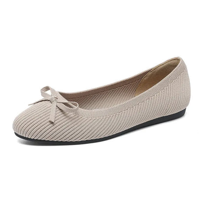 Women's black fabric flat pumps with a bow detail on the round toe, shown on a white background.