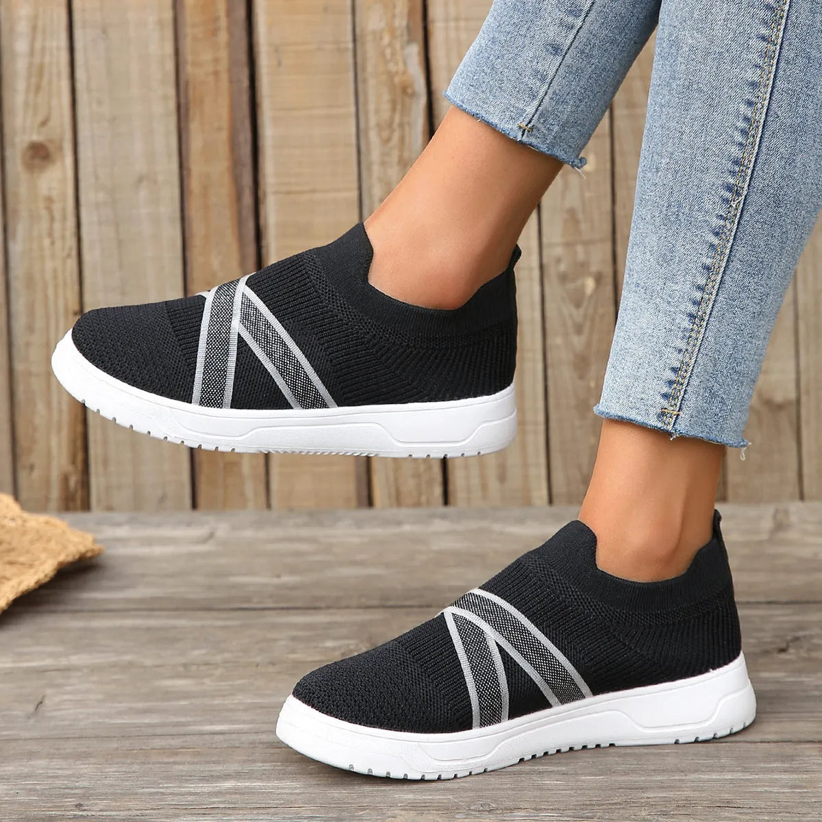 Black women's flyknit mesh flat shoes with rubber sole and tassel detail