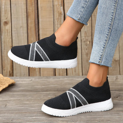Black women's flyknit mesh flat shoes with rubber sole and tassel detail