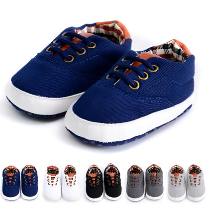 Baby canvas shoes in solid colour with soft bottom and front strap, sizes 11cm to 13cm