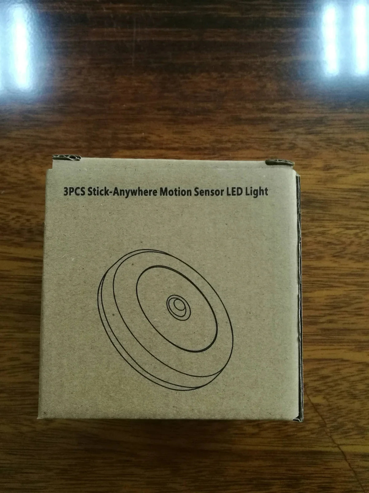 White motion-sensing LED cabinet lamp with magnetic back for wireless installation