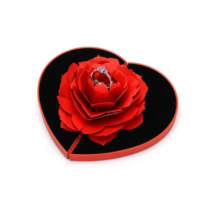 Red 3D heart-shaped plastic ring box with rose decoration on a rotating stand