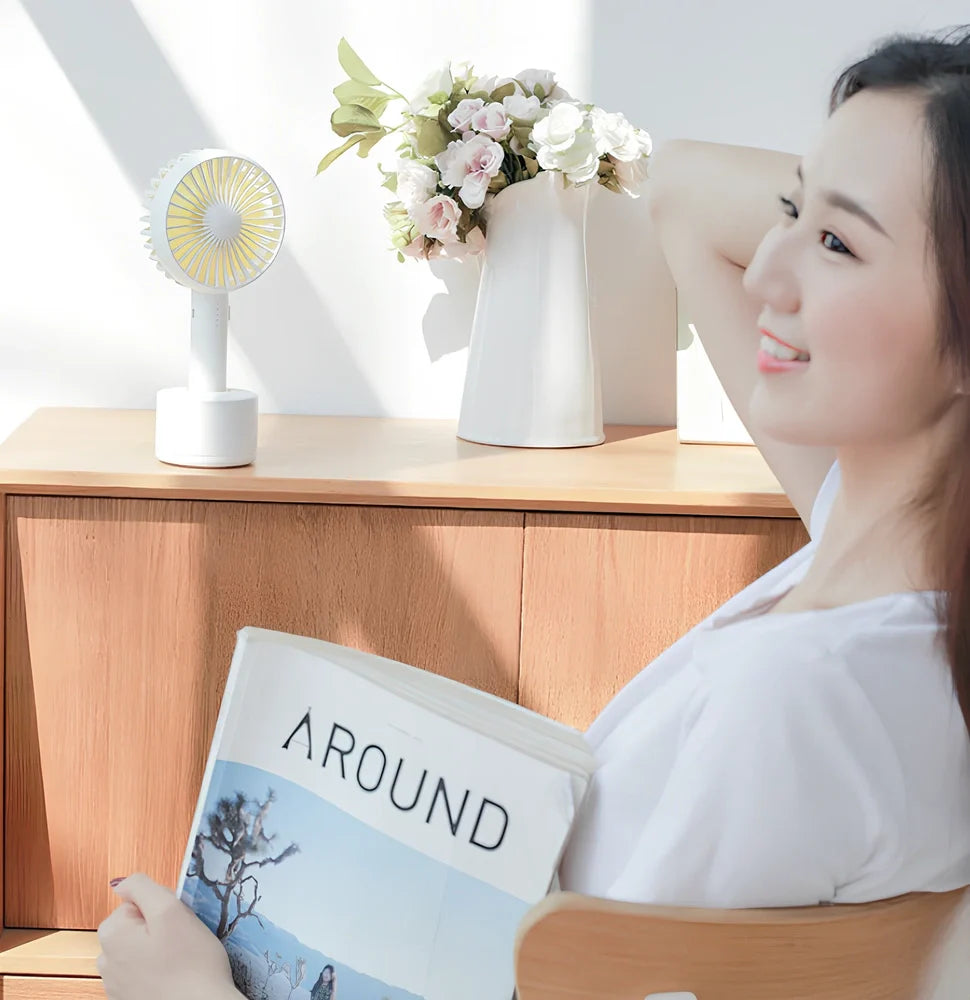 Blue shaking head handheld fan showing oscillating mechanism and USB charging port