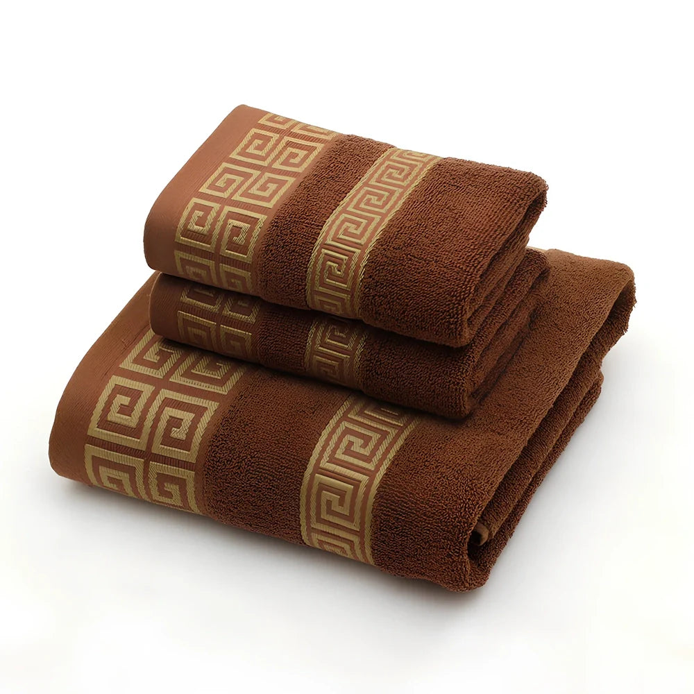 Three-piece cotton towel set showing 70cm bath towel and two 34cm hand towels in white, dark blue, and brown colours
