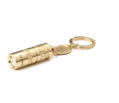 Gold electroplated waterproof mini LED keychain torch with zinc alloy body on a keyring.