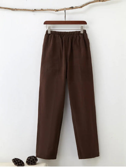 Men's beige pure cotton casual trousers with a drawstring waist on a mid-grey background.