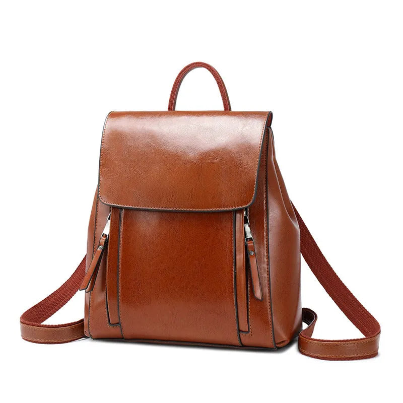 Genuine leather women's backpack with multiple compartments showing stitching details and cover-type opening