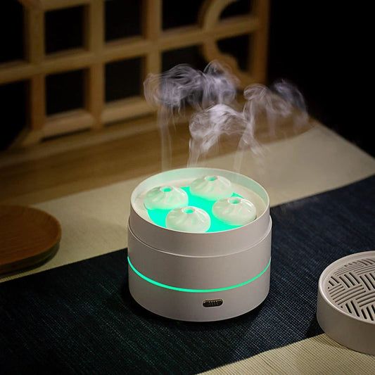 White ultrasonic essential oil diffuser with four spray nozzles and LED lighting display