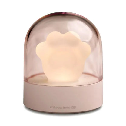 Grey cat paw shaped night light with USB port, sitting on a surface with soft glow.