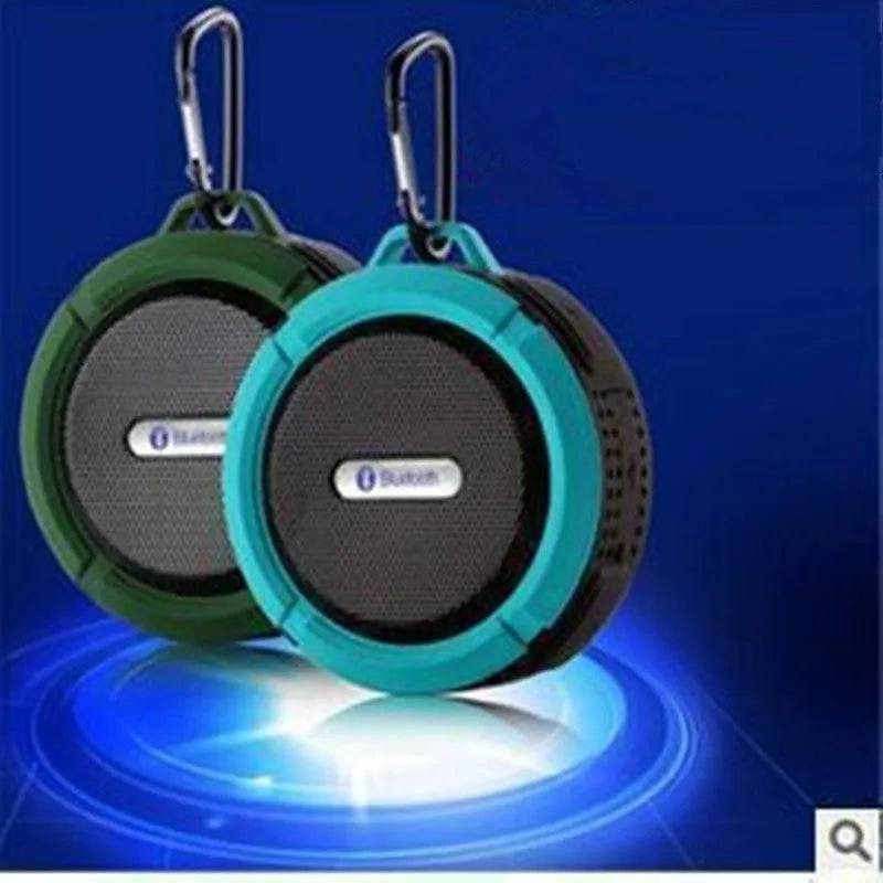 C6 portable waterproof Bluetooth speaker in multiple colours with a mounting clip attached.