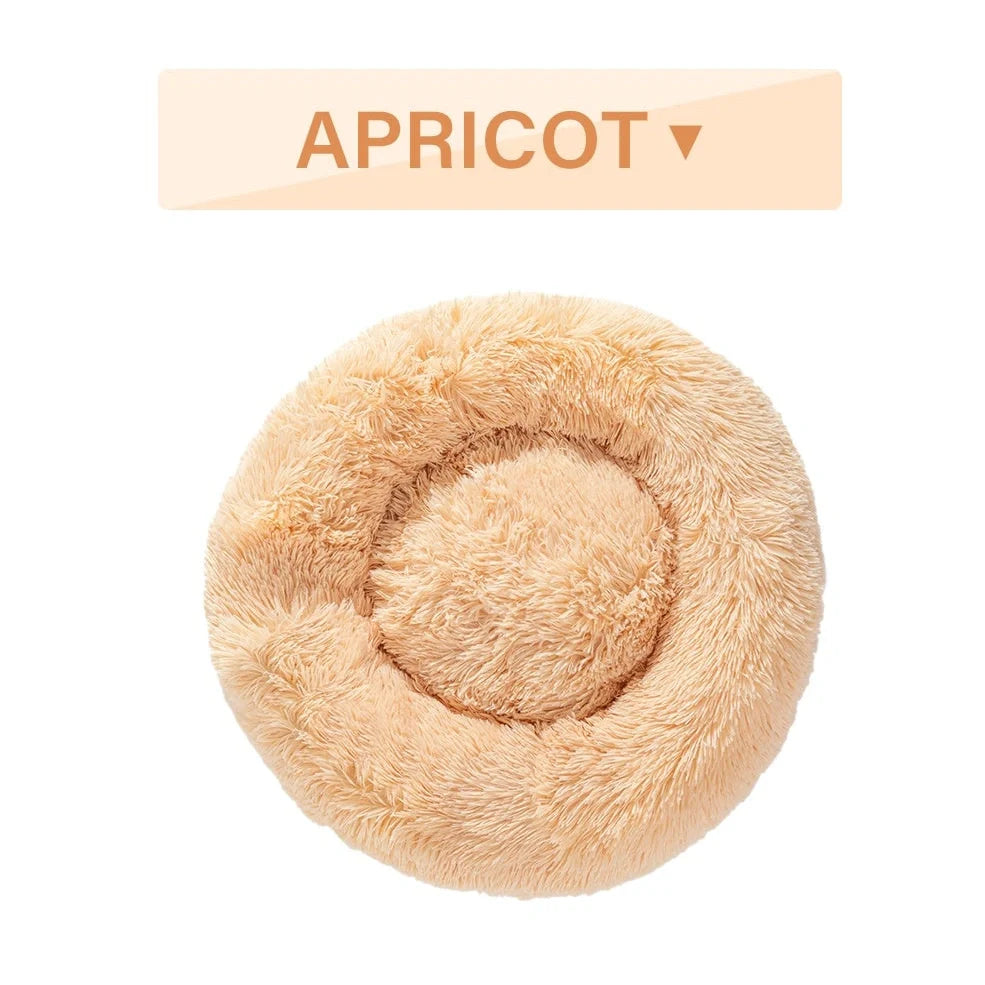 Fluffy donut-shaped dog bed in dark grey colour with raised edges, showing plush texture and circular design