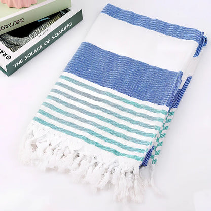 Striped Turkish beach towel showing blue and white pattern, measuring 100cm by 180cm