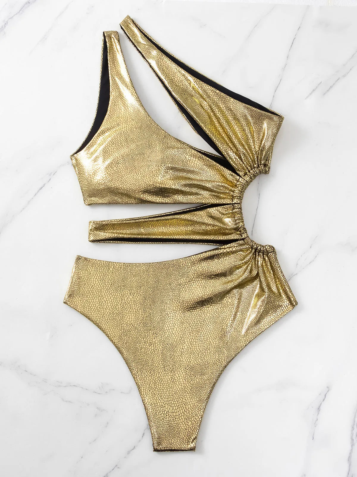 Women's gold one-piece swimsuit with backless design and spandex material