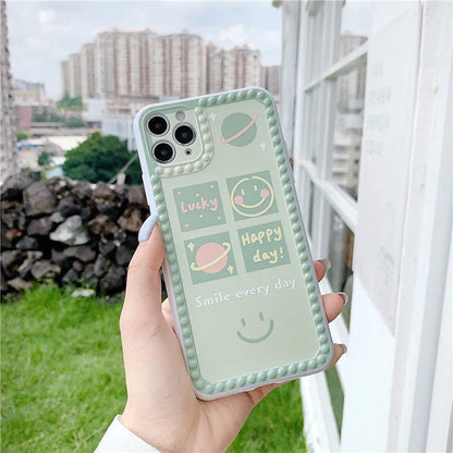 Green TPU iPhone case with geometric smiley face and polka dot frame design on a smartphone