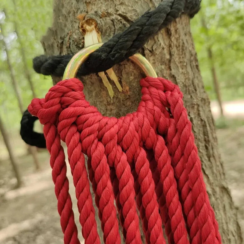Outdoor nylon rope mesh hammock with tying strap shown in use