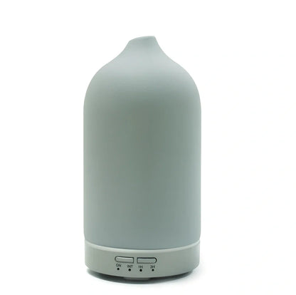 Ceramic ultrasonic aroma diffuser in white with 100ml tank, diffusing mist in home setting, 10cm diameter