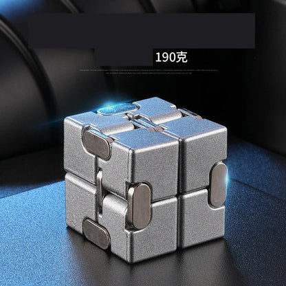 Zinc alloy Infinity Cube with eight rotating cubes showing black and silver colour options on wooden surface
