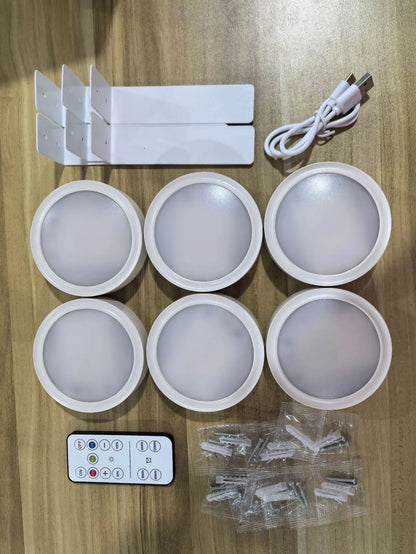 Black magnetic LED painting lamp with remote control on a white wall.