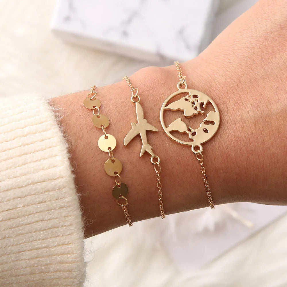 Set of three women's bohemian-style bracelets with heart charms showing an aircraft map design.