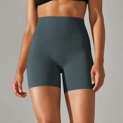 Woman wearing high waist hip lift fitness tights in a neutral colour, suitable for running or gym workout.