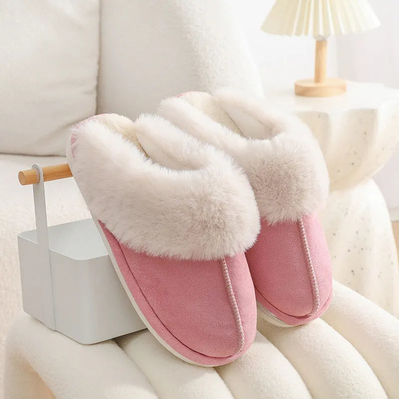 Women's plush indoor slippers in a selection of colours with a fuzzy upper and flat sole.