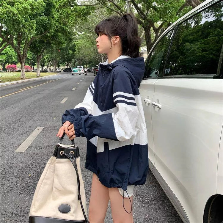 Women's lightweight hooded sun protection coat in blue, red, or orange