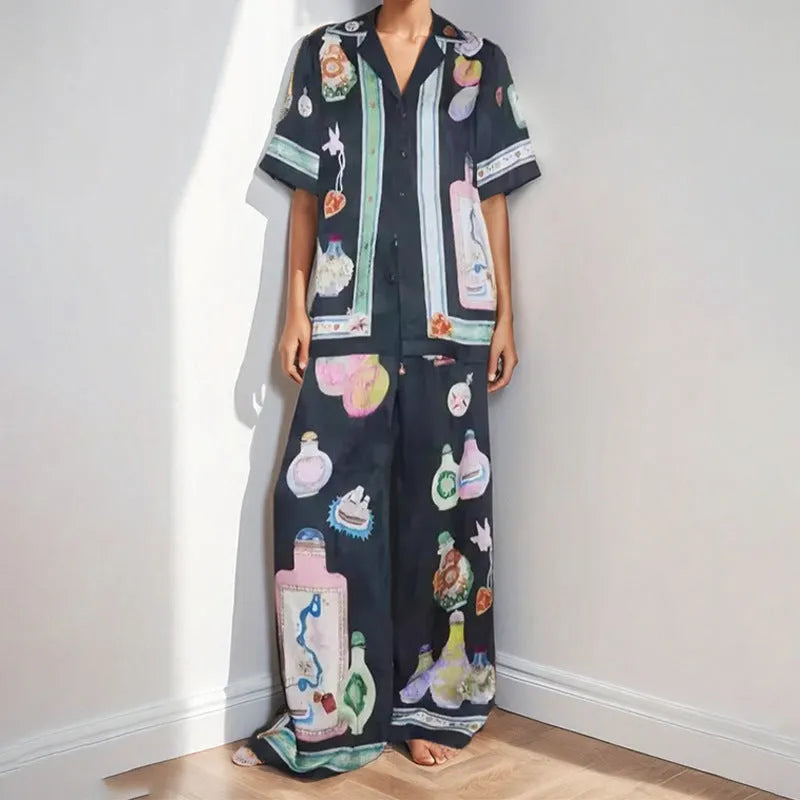 Black women's cardigan set with cartoon animation print, showing top with regular sleeves and matching trousers