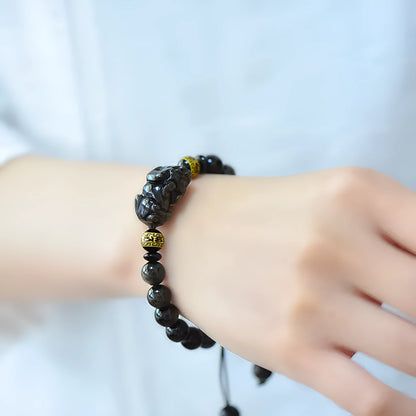 Hand-woven golden obsidian Pi Xiu bracelet with animal design, showing bead size options.