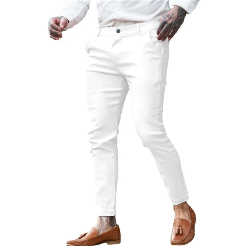 Men's slim fit elastic cotton pencil trousers in a solid colour on a hanger, showing the zip fly and mid waist design.