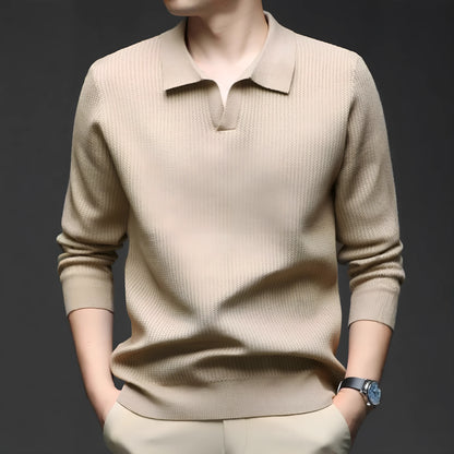 Man wearing a loose fit camel coloured pullover sweater, a casual autumn layer with a simple design.