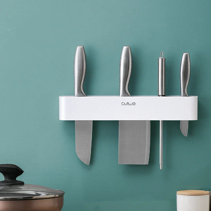 Sleek wall-mounted knife organizer with slots for knives and hooks for storing kitchen essentials