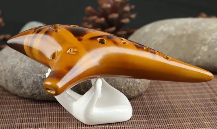 Ceramic 12-hole smoldering ocarina in alto C pitch with nest-inspired design