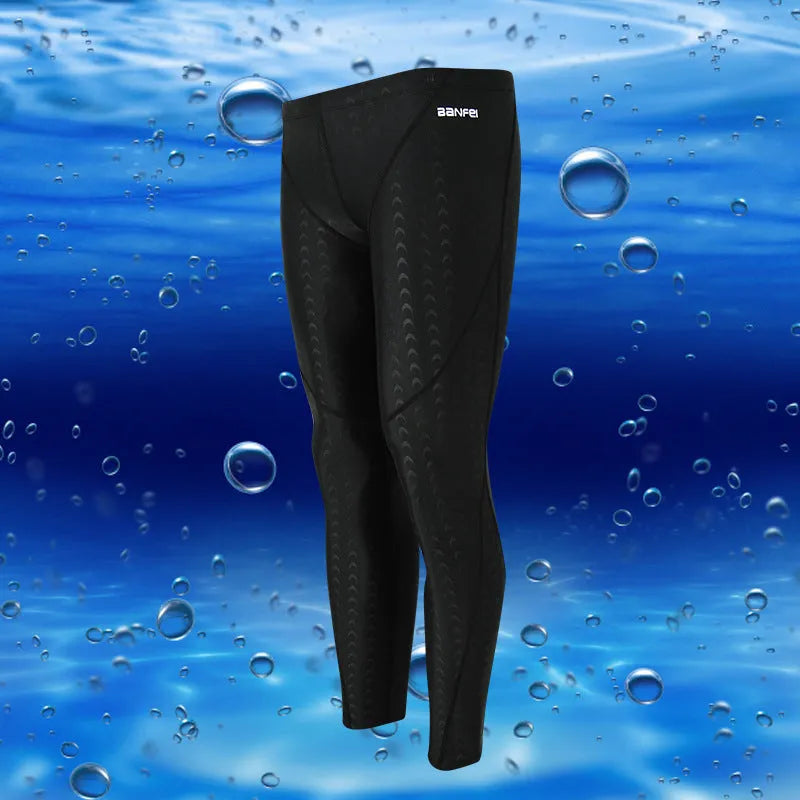 Men's black and grey cropped nylon swimming trunks with mesh lining, laid flat.