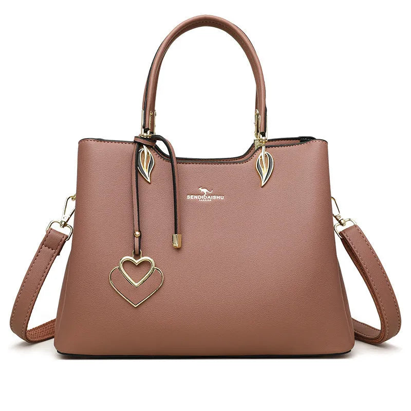 Women's black PU leather messenger bag with multi-layer shoulder strap and sewing thread detailing.