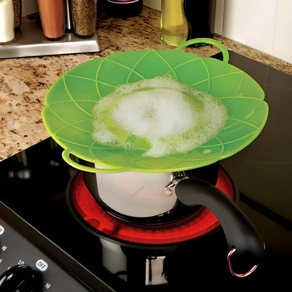 Green silicone spill stopper pan lid on cooking pot showing flexible edges and steam vent