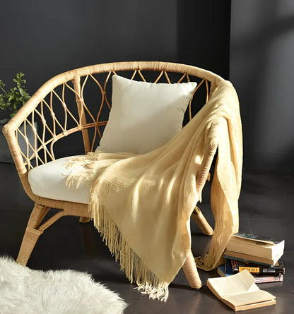 130x150cm knitted acrylic blanket with 10cm fringe detailing in beige colour draped over sofa