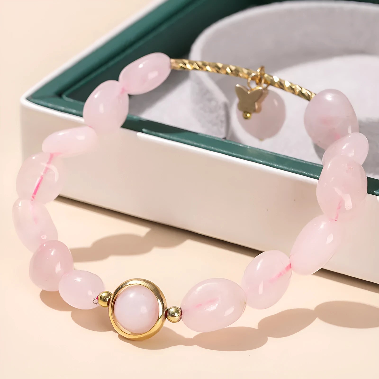 Close-up of a manually crafted crystal agate bracelet with shaped animal and fruit beads.