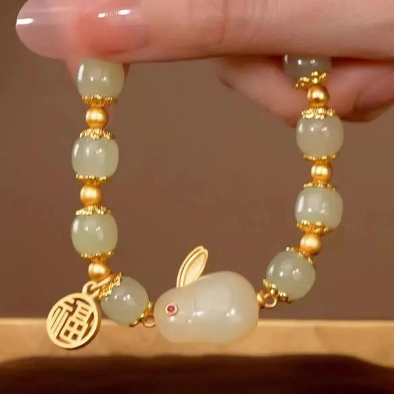 Women's lucky jade bracelet featuring a green fu character hare charm with lily detailing, 10g weight, classic black cord adjustable design for spiritual protection and personal adornment.