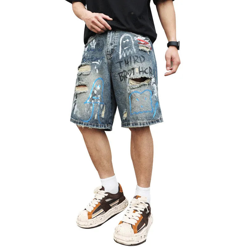 Blue denim men's shorts with ripped knees and graffiti design, featuring a straight leg and zipper fly.