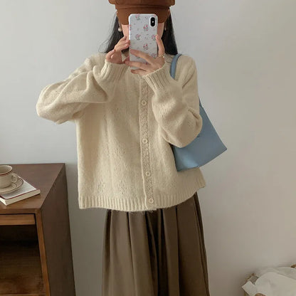 Loose-fitting artistic retro sweater coat in viscose fibre, shown in apricot colour.