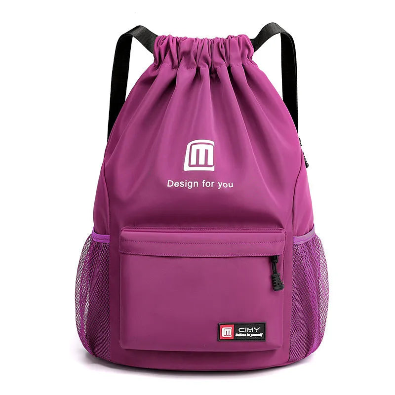 Large bucket-shaped travel backpack in blue with drawstring closure and soft black shoulder straps.